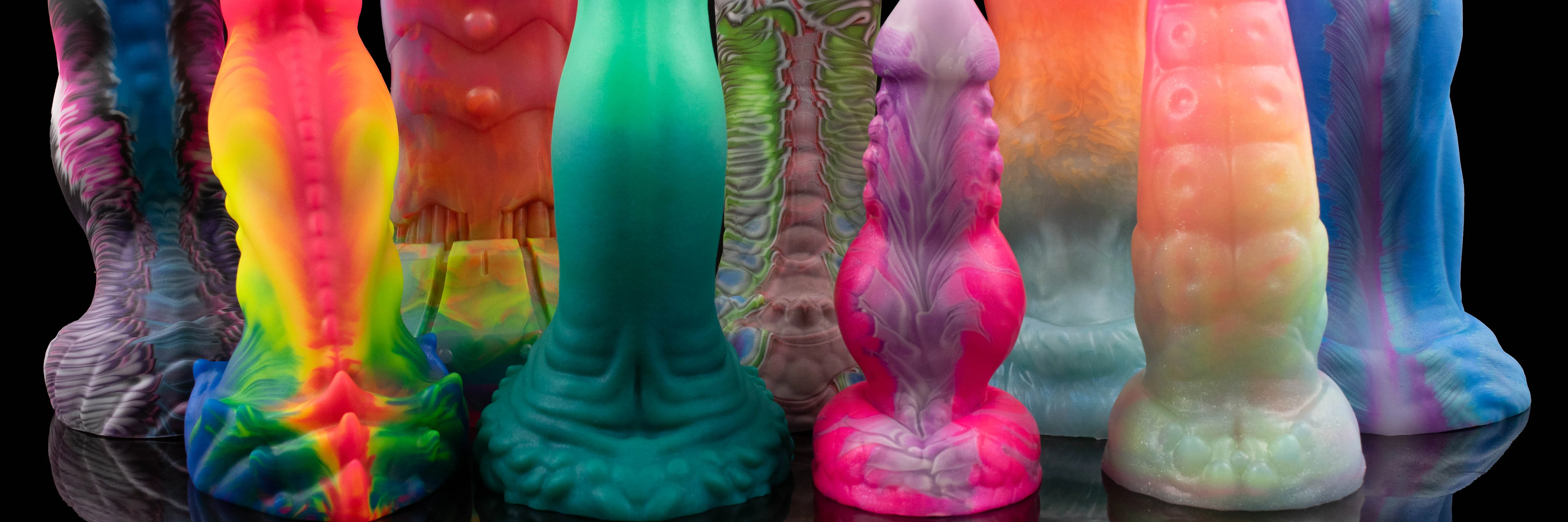 A collection of nine vibrantly colored fantasy dildos.